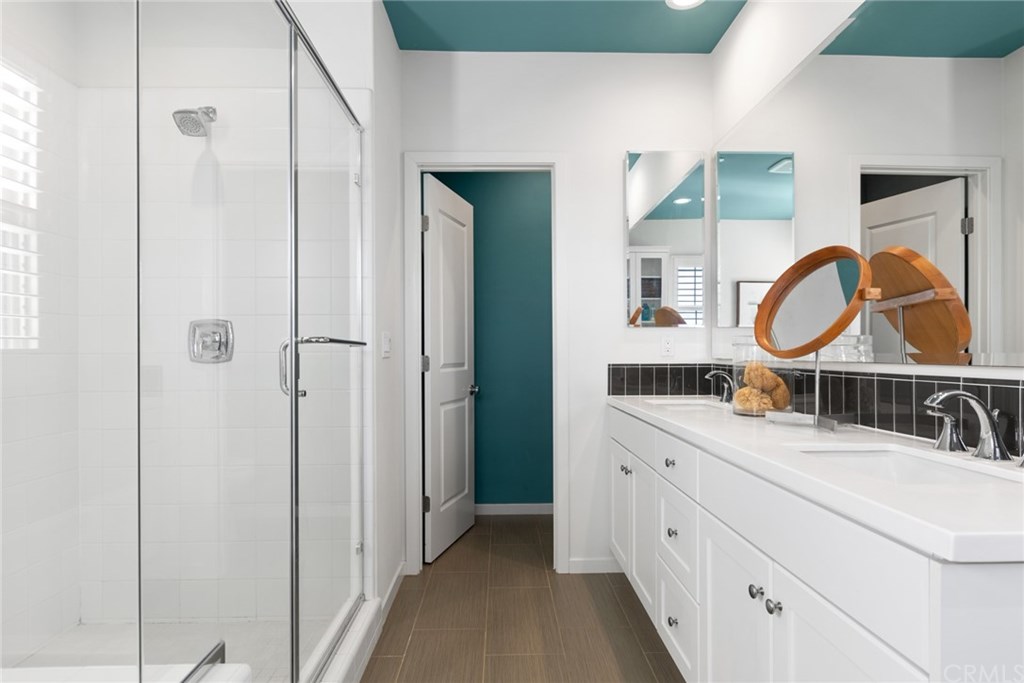 53 Kestrel Irvine, CA 92618 - Photo 18 of 39 Marble counters, ceramic tile, walk-in shower, privacy door & dual vanity sinks are only some bathroom perks