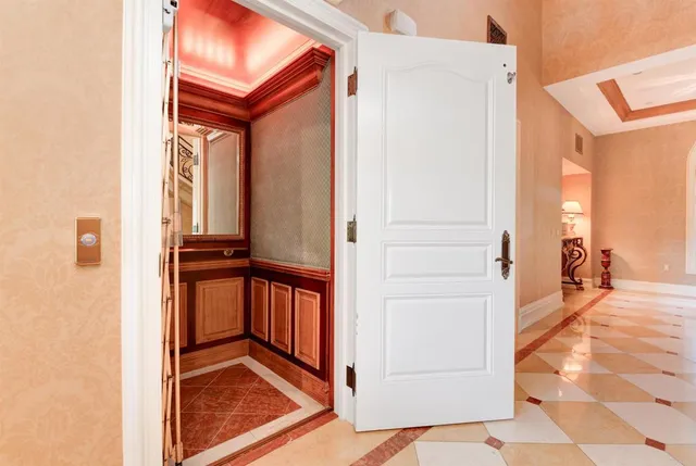 a view of a hallway and a livingroom with furniture