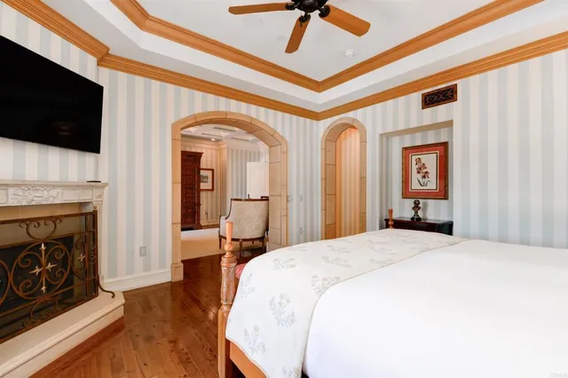 a spacious bedroom with a bed and a flat screen tv