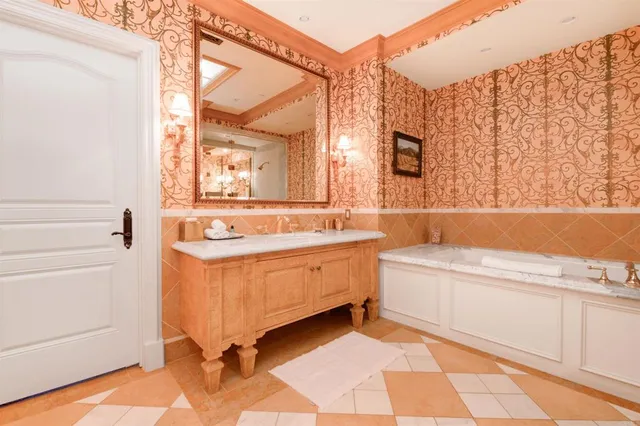 a bathroom with a bathtub sink and a mirror