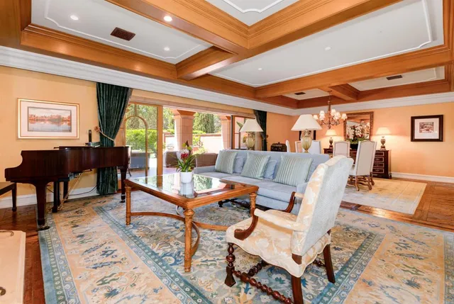 a living room with furniture a rug and a large window