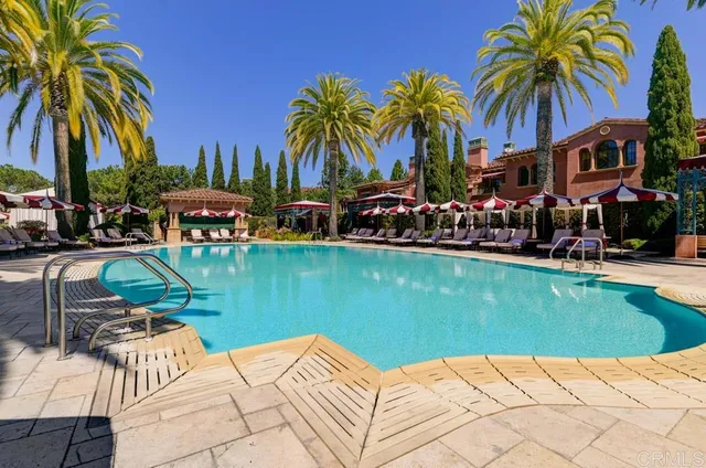 a view of swimming pool with a table and chairs