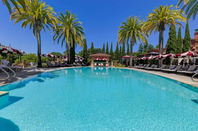 a view of a swimming pool with a table and chairs