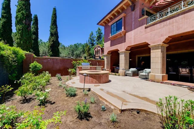 a view of a patio with table and chairs potted plants and palm tree