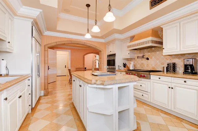 a kitchen with stainless steel appliances granite countertop a sink and cabinets