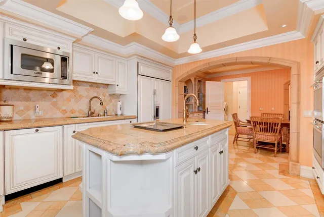 a kitchen with stainless steel appliances granite countertop a sink and dishwasher cabinets with wooden floor