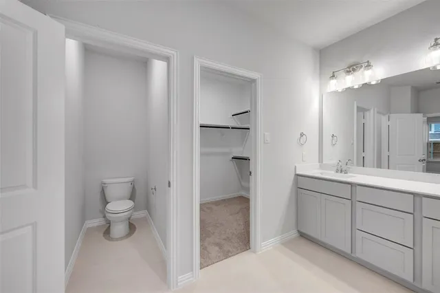 a bathroom with a double vanity sink toilet and shower