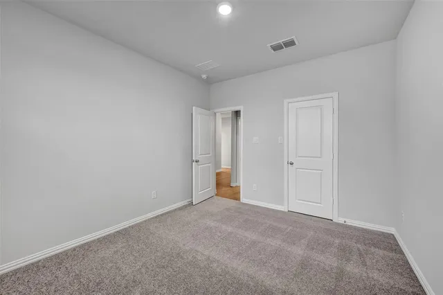 a view of an empty room and a window