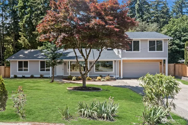 a front view of a house with a garden