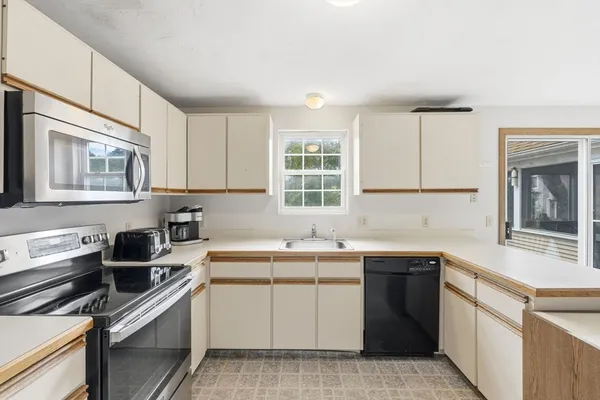 a kitchen with a sink stove and cabinets