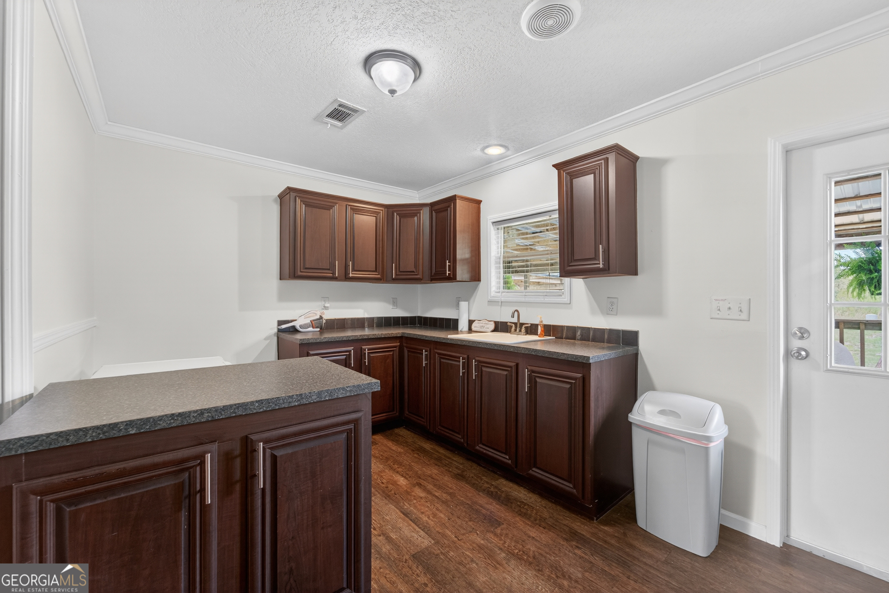1953 Raybon Road West Hoboken, GA 31542 - Photo 23 of 31 a kitchen with a sink cabinets and wooden floor