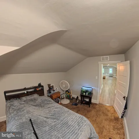 a bedroom with a bed and green walls