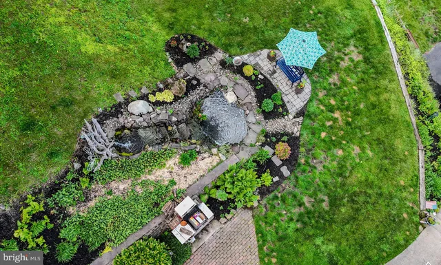 an aerial view of a house with a yard and outdoor seating