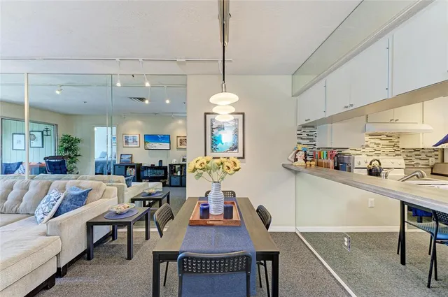 a living room with furniture a chandelier and a table