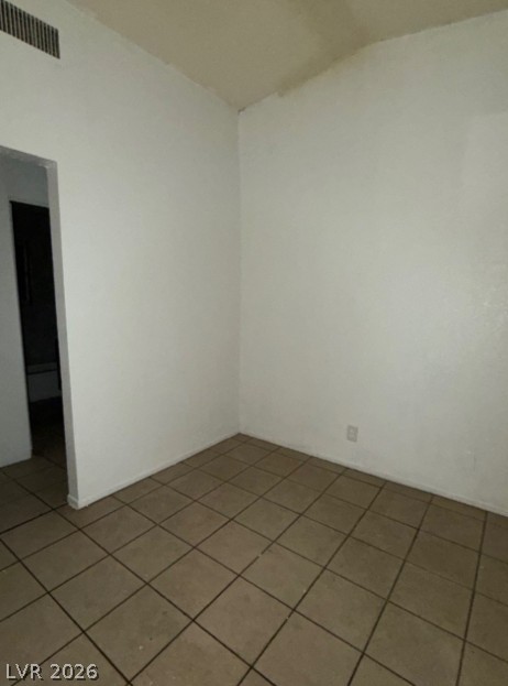 521 North Decatur Boulevard, Unit B Las Vegas, NV 89107 - Photo 3 of 17 A well-maintained living area features durable tile flooring, offering a blank canvas for personalization.