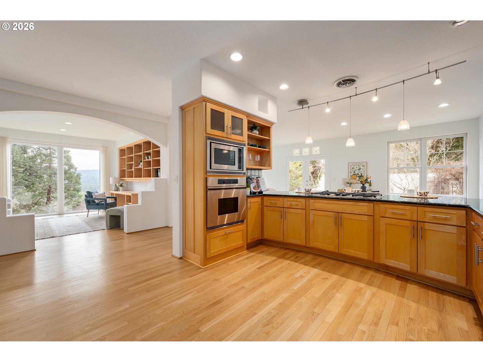 4015 Spring Knoll Drive Eugene, OR 97405 - Photo 11 of 48 a large kitchen with stainless steel appliances granite countertop a large counter top and a wooden floors