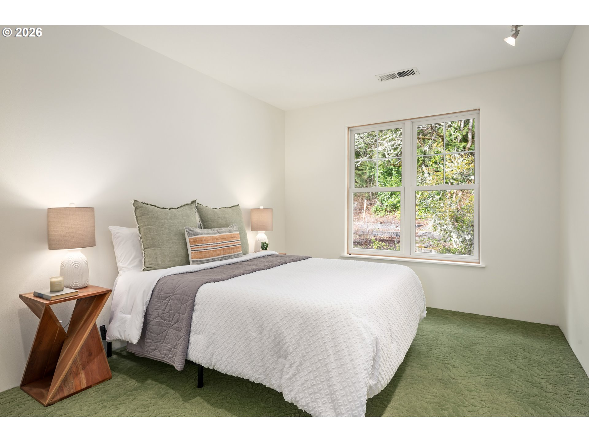 4015 Spring Knoll Drive Eugene, OR 97405 - Photo 31 of 48 a bedroom with a bed and a night stand