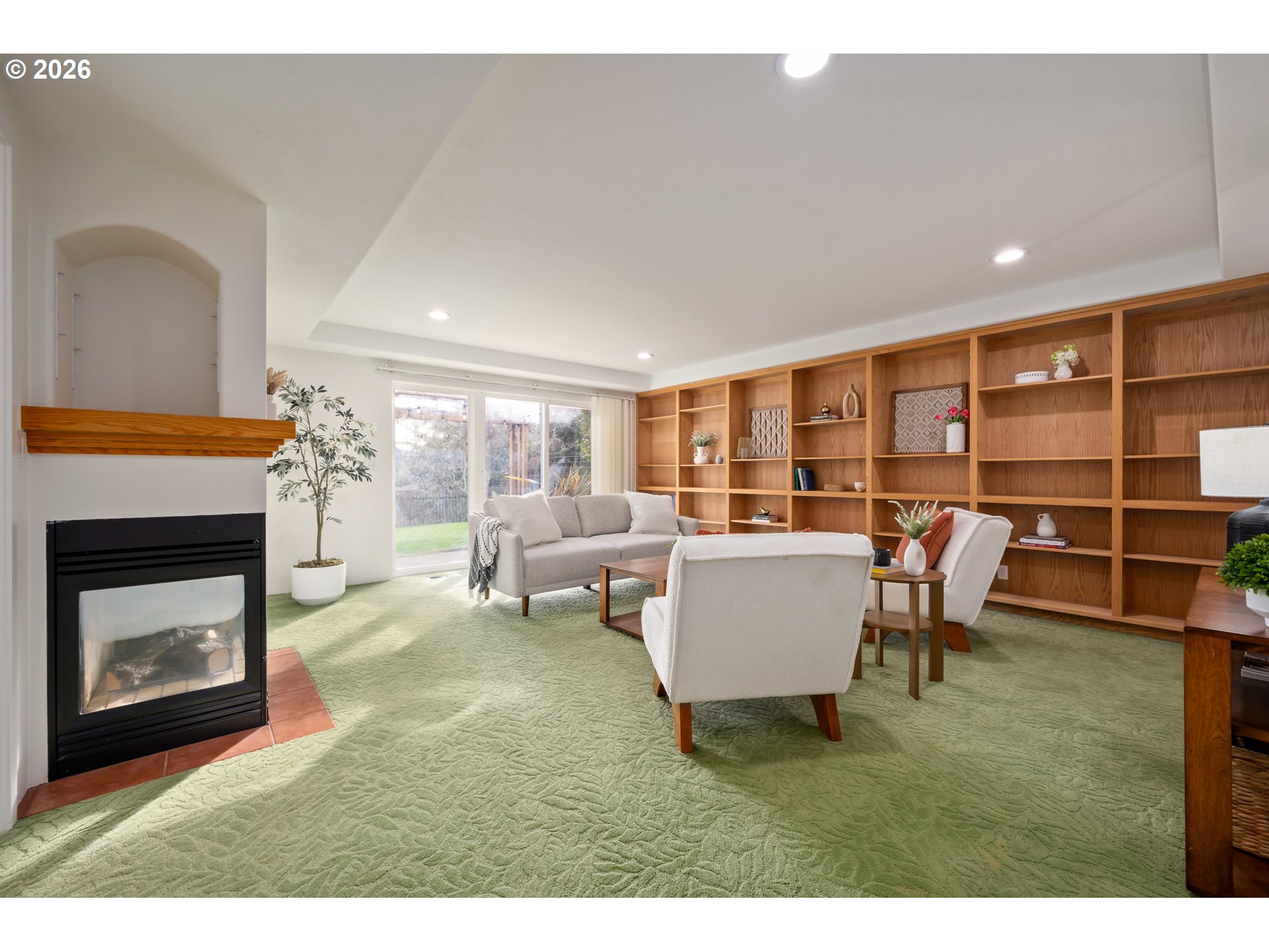 4015 Spring Knoll Drive Eugene, OR 97405 - Photo 35 of 48 a living room with furniture a fireplace and a floor to ceiling window
