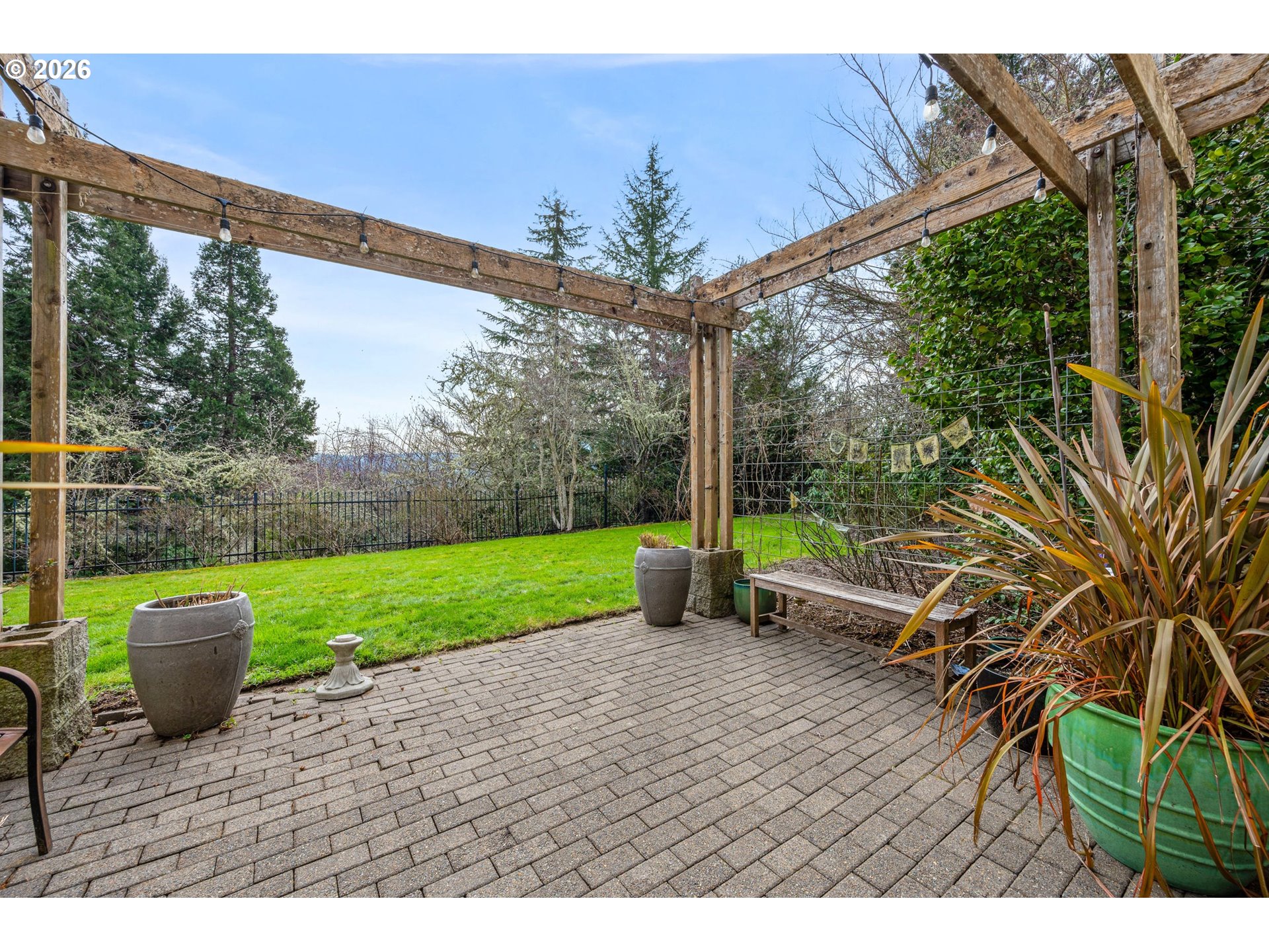 4015 Spring Knoll Drive Eugene, OR 97405 - Photo 43 of 48 a view of a patio with table and chairs potted plants with wooden floor and fence