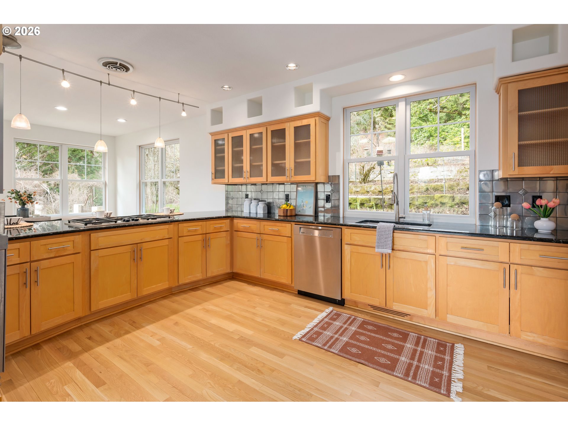 4015 Spring Knoll Drive Eugene, OR 97405 - Photo 9 of 48 a kitchen with stainless steel appliances granite countertop a sink cabinets and wooden floor
