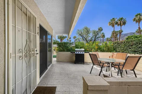 a view of a patio with table and chairs and potted plants