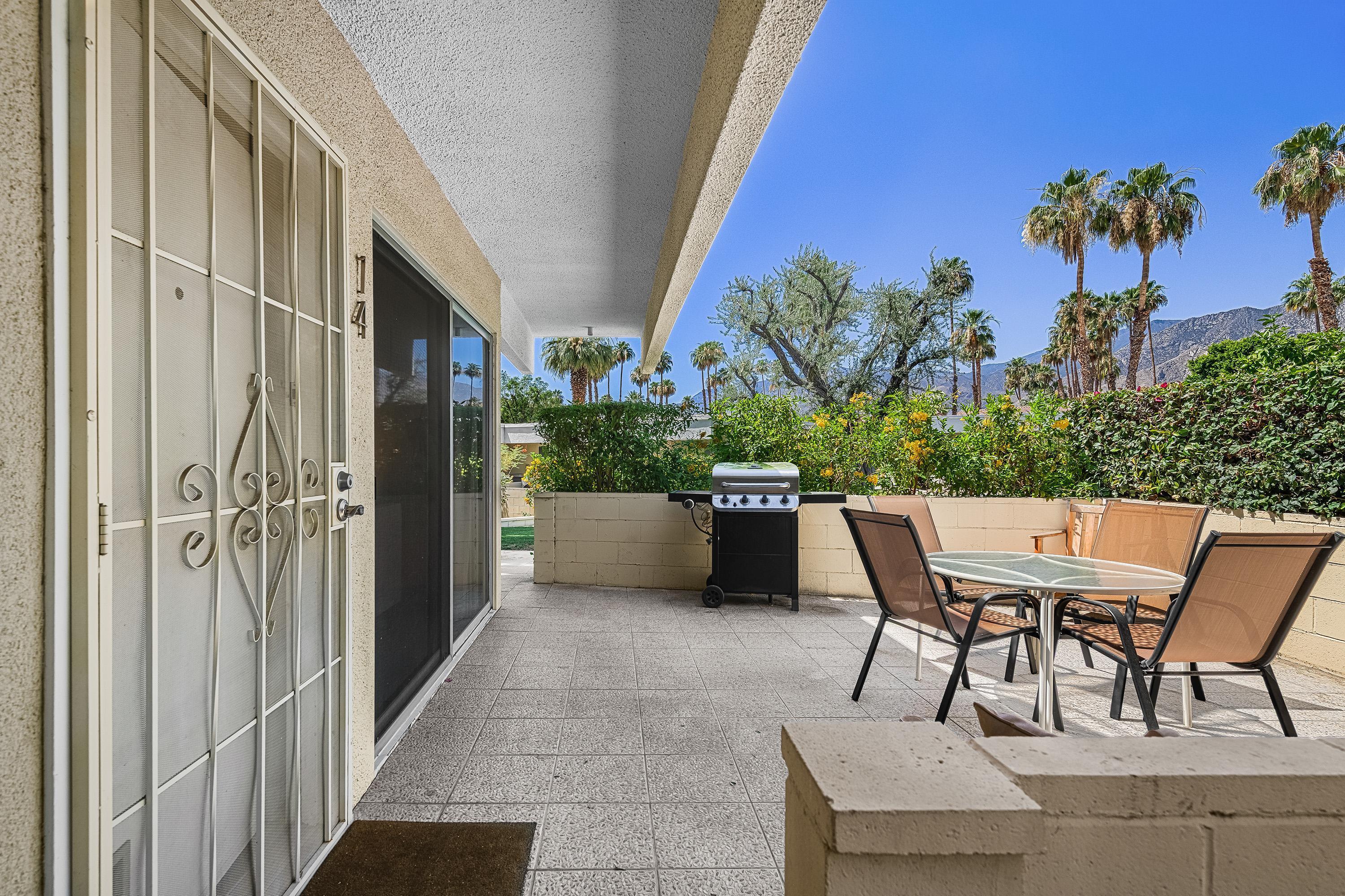 1855 Ramon Road, Unit 14 Palm Springs, CA 92264 - Photo 5 of 34 a view of a patio with table and chairs and potted plants