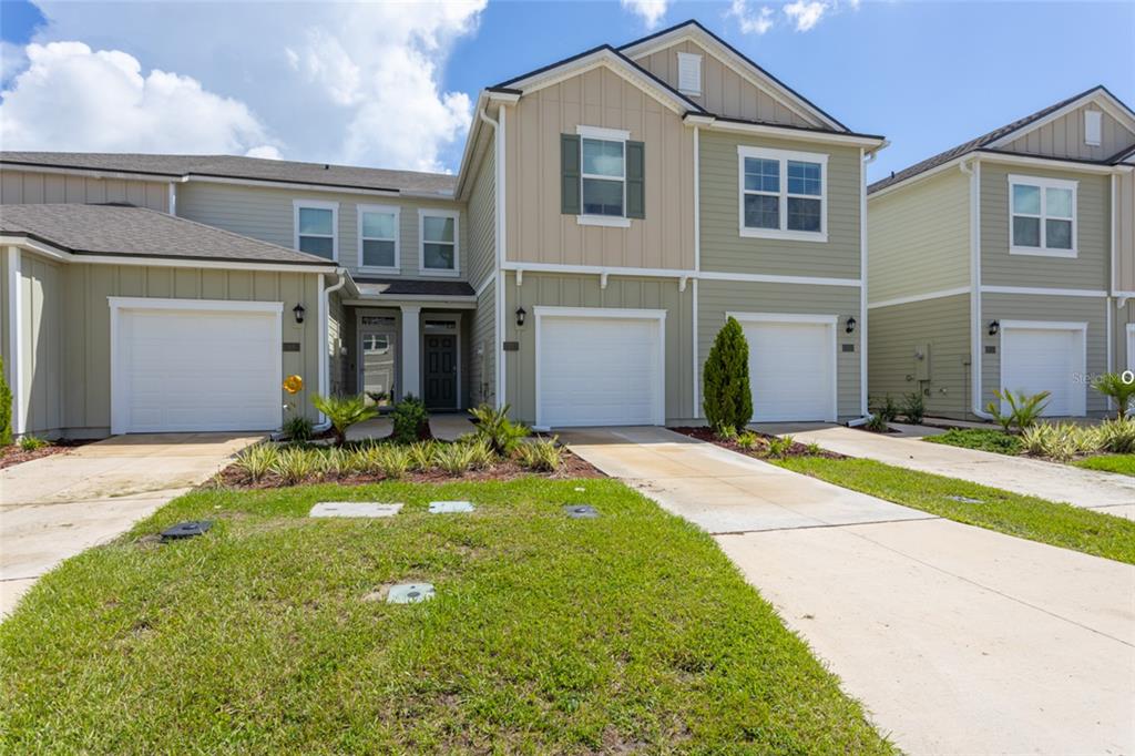a front view of a house with a yard and garage