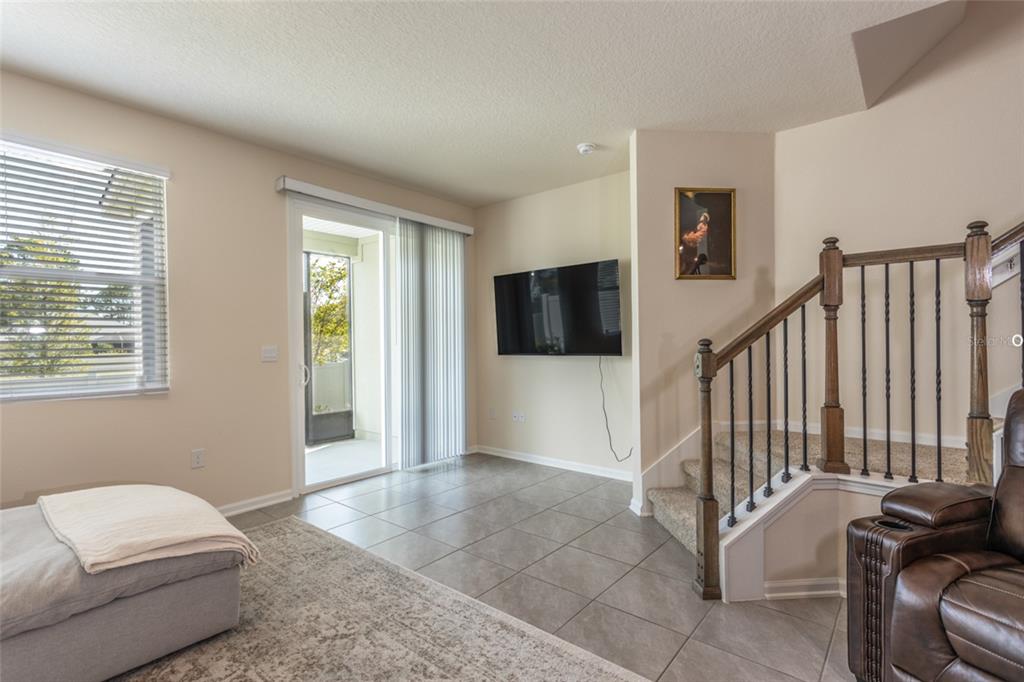 71 Redbud Road Palm Coast, FL 32137 - Photo 12 of 32 a living room with furniture and a flat screen tv