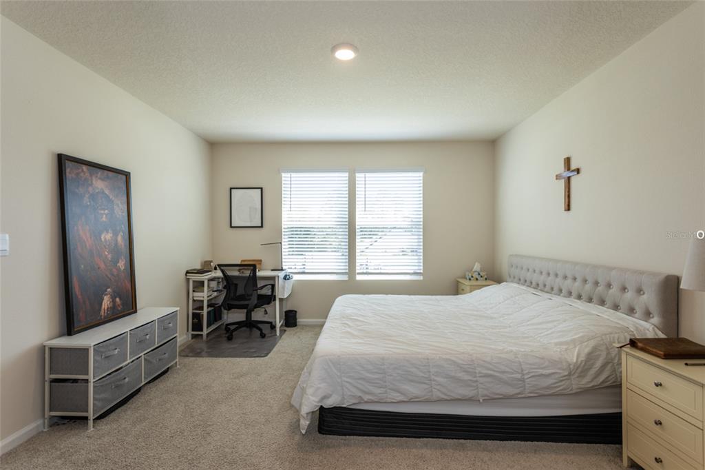 71 Redbud Road Palm Coast, FL 32137 - Photo 13 of 32 a bedroom with a bed and a furniture