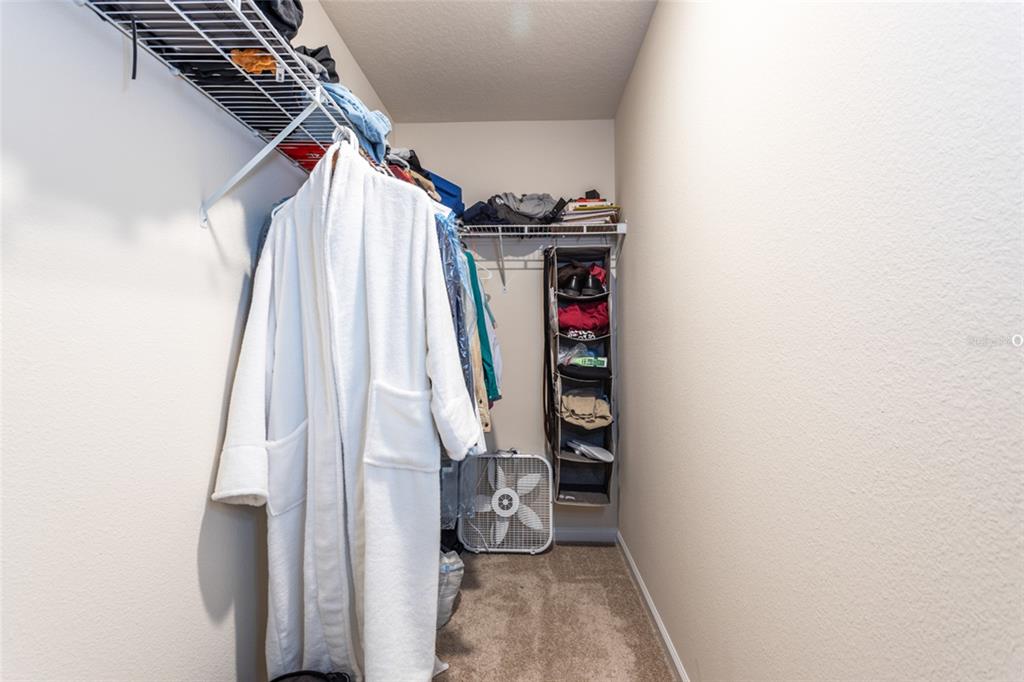 71 Redbud Road Palm Coast, FL 32137 - Photo 15 of 32 a view of walk in closet with clothes and shoes