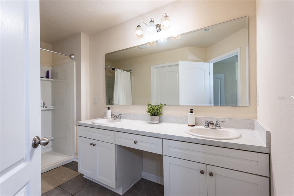 71 Redbud Road Palm Coast, FL 32137 - Photo 16 of 32 a bathroom with a double vanity sink mirror and