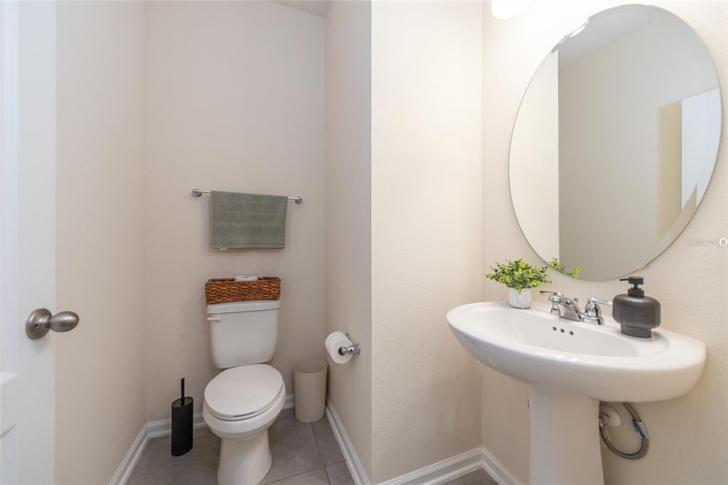 71 Redbud Road Palm Coast, FL 32137 - Photo 20 of 32 a bathroom with a toilet sink and mirror