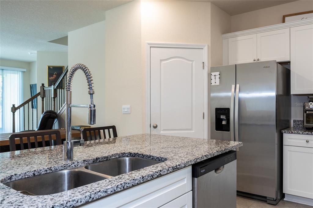 71 Redbud Road Palm Coast, FL 32137 - Photo 5 of 32 a kitchen with a granite countertop sink and refrigerator