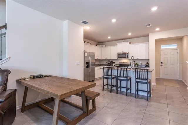 a kitchen with a table and chairs in it