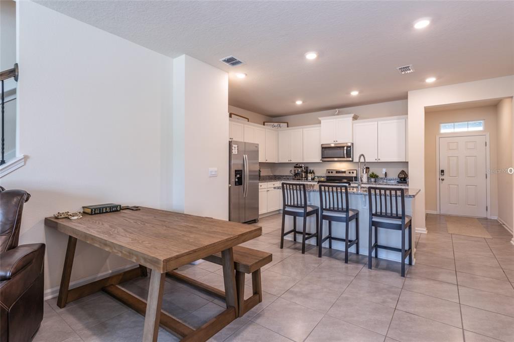 71 Redbud Road Palm Coast, FL 32137 - Photo 8 of 32 a kitchen with a table and chairs in it