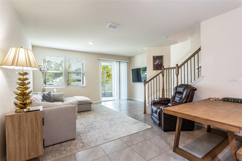 71 Redbud Road Palm Coast, FL 32137 - Photo 10 of 32 a living room with furniture stairs and a window