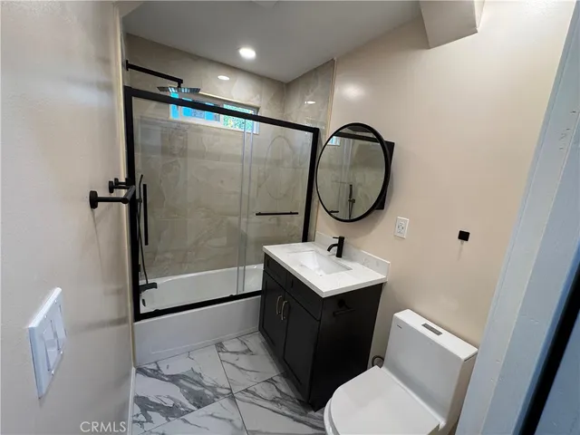 a bathroom with a toilet a sink and a mirror