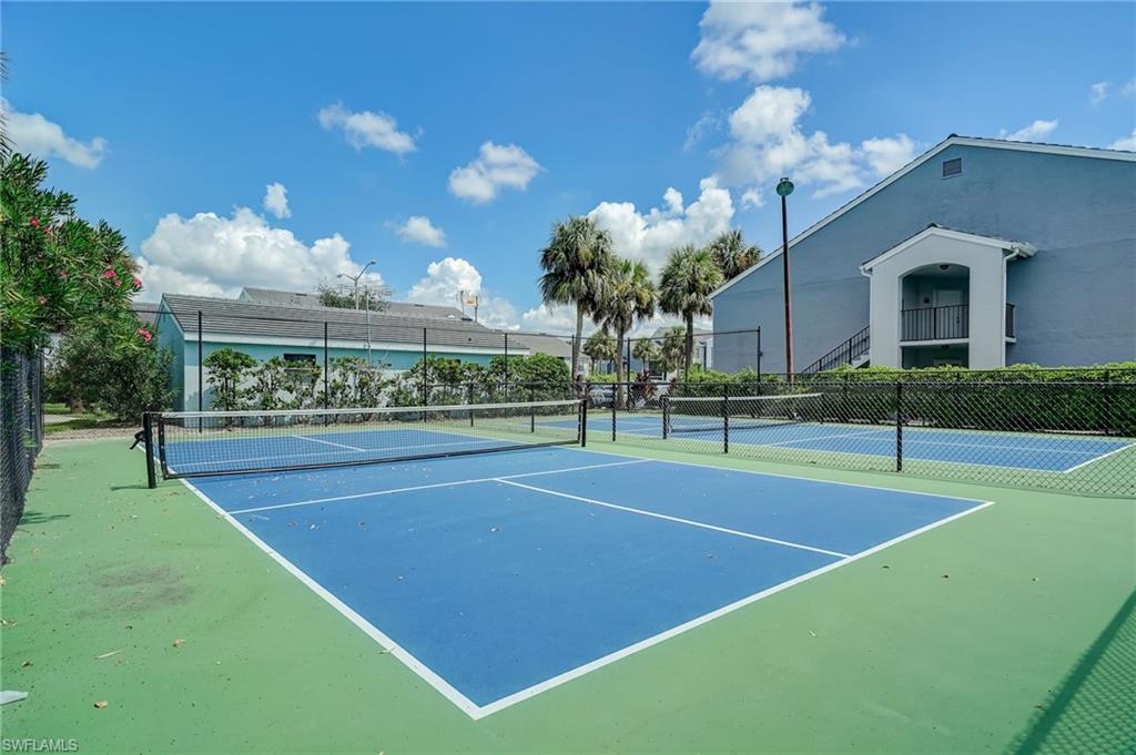 13615 Eagle Ridge Drive, Unit 1614 Fort Myers, FL 33912 - Photo 7 of 34 Kitchen featuring light wood-finish flooring, light countertops, and light cabinetry