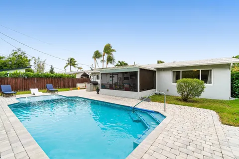 a view of a house with swimming pool and sitting area