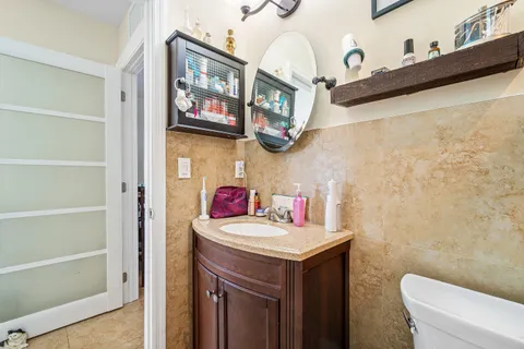 a bathroom with a sink a toilet and a mirror