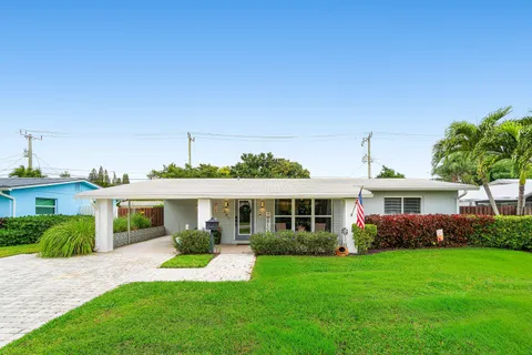 a front view of a house with a yard table and chairs