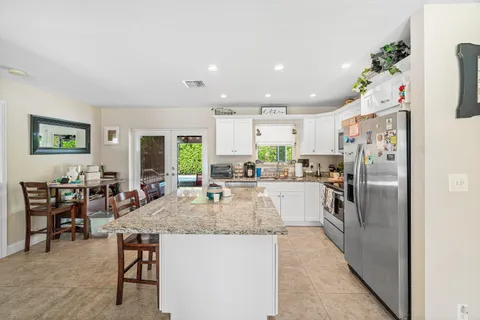 a kitchen with refrigerator and window