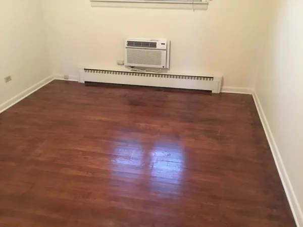 a view of a room with wooden floor