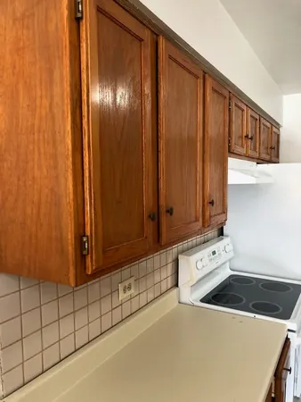 a view of an empty room and wooden shelves