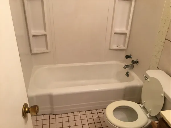 a bathroom with a sink a toilet and bathtub
