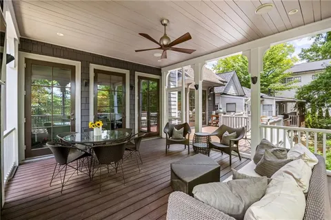 a living room with patio furniture and a floor to ceiling window