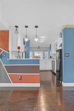 a view of kitchen and kitchen with furniture and refrigerator
