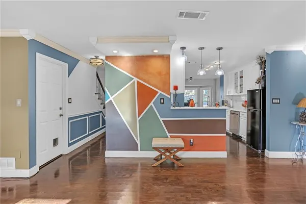 a living room with furniture and a wooden floor