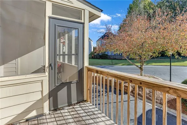 a view of a balcony with wooden floor and fence