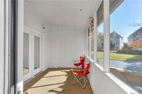 a view of a balcony with dining area and glass doors